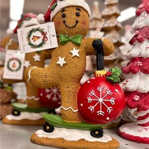 Festive Gingerbread Figurine riding scooter with Red Ornament